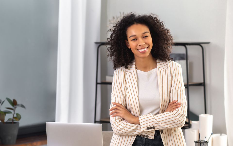 A smiling professional standing in a modern office