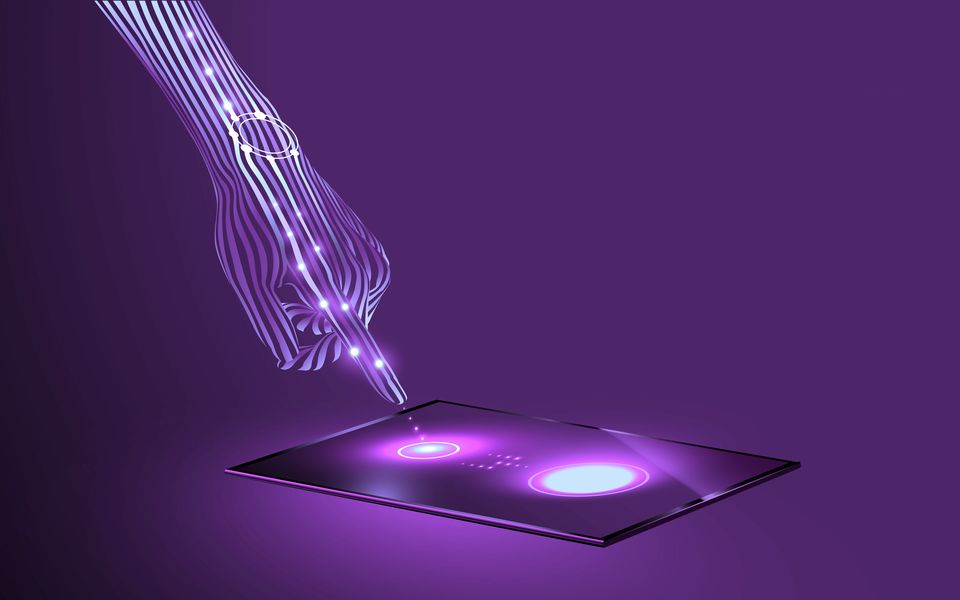 A hand touching a glowing digital screen