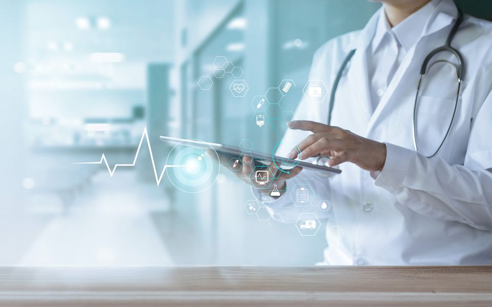 A doctor using a digital health tablet